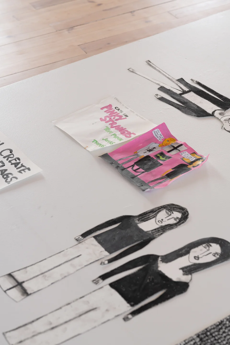 Pinky Stranges notebook and cutout figures on a floor display