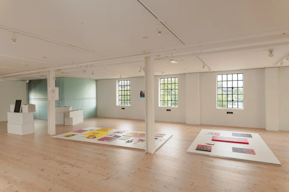 Overview of the exhibition with paintings and notebook displays