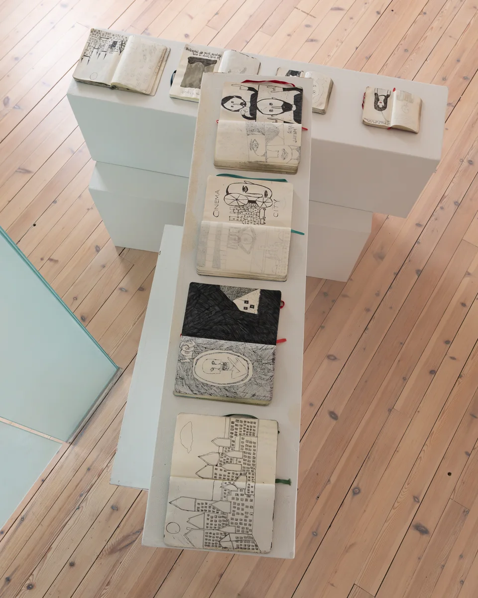 Overhead view of notebooks on intersecting plinths