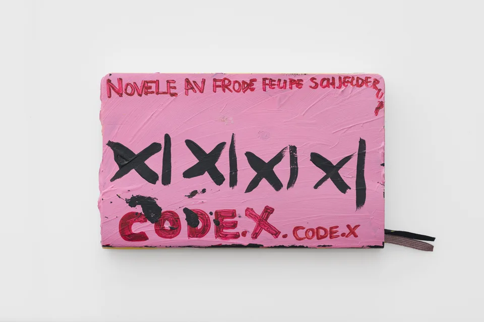 A pink painted notebook cover reading CODE-X.
